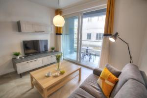 a living room with a couch and a tv and a table at Bright and beautifully furnished apartment close to seafront BFRA1-2 in Il-Gżira