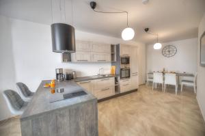 a kitchen with white cabinets and a counter top at Bright and beautifully furnished apartment close to seafront BFRA1-2 in Il-Gżira