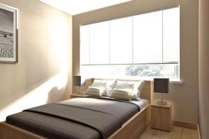 1 dormitorio con 1 cama y ventana grande en Apartments, Niechorze en Niechorze