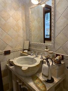 a bathroom with a sink and a mirror at Maidalchini House in Acquapendente +21 photos