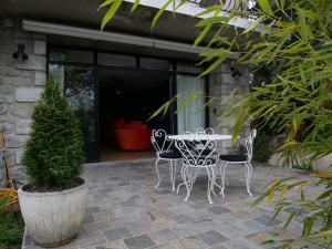 a patio with a table and chairs in front of a building at Suite 24 in Aubenas