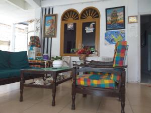 a living room with two chairs and a couch at Kenangan Guest House in Sabang