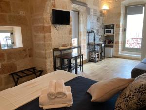 a bedroom with a bed with two towels on it at Tresor 65 in Polignano a Mare