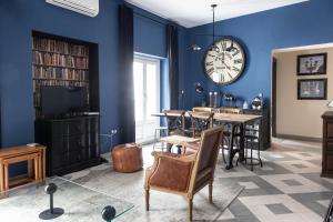 a living room with a large clock on the wall at Blue Home by Cadiz Time in Cádiz