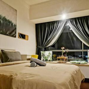 a bedroom with a large bed and a large window at R&F Mall,Country Style Seaview 2 bedrooms in Johor Bahru