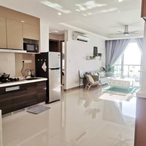 a kitchen and living room with a refrigerator at R&F Mall,Country Style Seaview 2 bedrooms in Johor Bahru