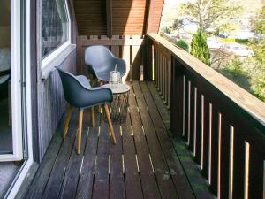 a porch with two chairs and a table on it at Holiday Home Andrea by Interhome in Hausen