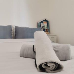 a rolled up towel on a bed in a living room at R&F Mall,Country Style Seaview 2 bedrooms in Johor Bahru