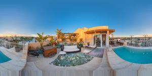 a house with a swimming pool on top of a building at Lulu Boutique Hotel in Żebbuġ