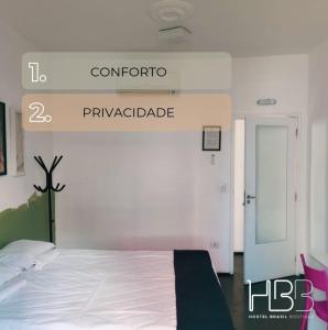 a bedroom with a bed and a sign that readsynchronous sqor at HBB Hostel - Vila Madalena in Sao Paulo