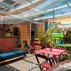 a patio with a table and a bench and a table and chairs at HBB Hostel - Vila Madalena in Sao Paulo