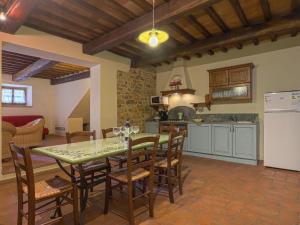 a kitchen and dining room with a table and chairs at Apartment Boccaccio by Interhome in San Donato in Poggio