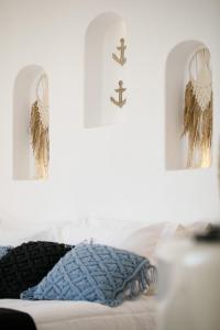 two crosses hanging on a wall next to a bed at Naxos Earth Suites in Mikri Vigla