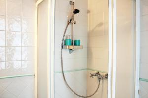 a shower with a hose in a bathroom at La di Morson Agriturismo in Camino al Tagliamento +42 photos