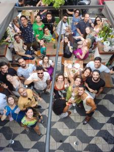 a group of people sitting around a table at HBB Hostel - Vila Madalena in Sao Paulo