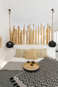 a room with a bed with two glasses of wine at Naxos Earth Suites in Mikri Vigla