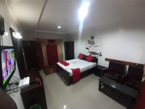 a bedroom with a bed and a television in it at kurinji residency in Ooty