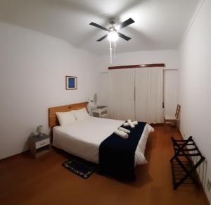 a bedroom with a bed and a ceiling fan at Adamas Bed & Breakfast in Ponta Delgada