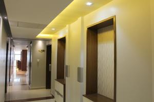 a hallway with a mirror on the wall at NAAS Serviced Apartments in Dhaka