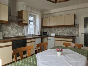 a kitchen with a table with a white table cloth at Haus Am Battenstein in Hilders