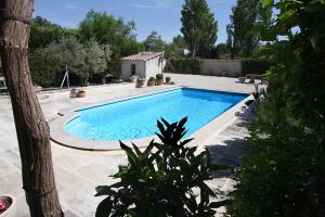 a large swimming pool in a yard at CLOS DE LA FONT in Mollégès
