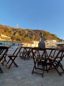 a group of picnic tables sitting on a patio at Hotel Dallas Toríbio in Bom Jesus da Lapa