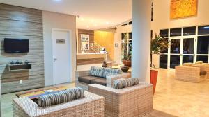 a living room with two couches and a tv at Atlantic Palace Family inn in Aquiraz