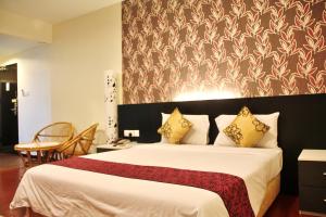 a bedroom with a large white bed with a red blanket at Prince Hotel in Tawau