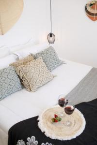 a bed with a tray with two candles on it at Naxos Earth Suites in Mikri Vigla