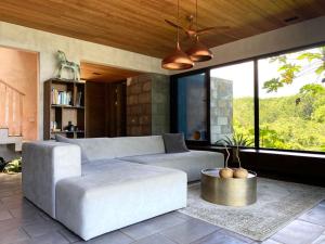 a living room with a couch and a table at THEA Resort & Retreats - Santa Teresa in Santa Teresa Beach