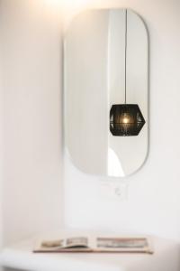 a black light fixture hanging from a mirror at Naxos Earth Suites in Mikri Vigla