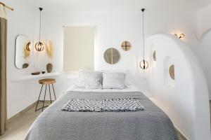 2 camas en una habitación con paredes blancas y espejos en Naxos Earth Suites, en Mikri Vigla 37 fotos más