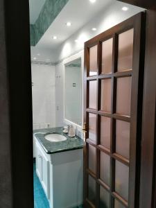 a bathroom with a sink and a mirror at Sardinia B&B house in Olbia +18 photos