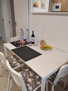 a white table with two chairs and bottles of water at Casa Guanche in Puerto del Rosario