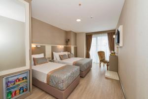 Postel nebo postele na pokoji v ubytování Marcello Hotel