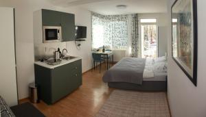 ein Schlafzimmer mit einem Bett und eine Küche mit einem Waschbecken in der Unterkunft Apartmán u Doktora in Banská Bystrica