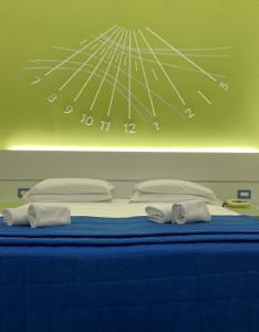 a bed with blue sheets and pillows in a room at Hotel La Meridiana in Sorrento
