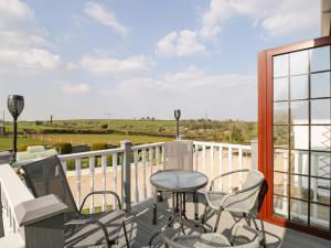 a patio with a table and chairs on a balcony at Annex Chetnole in Bristol