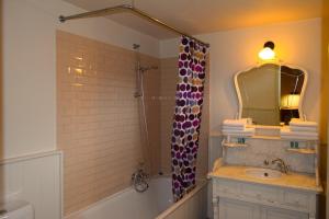 a bathroom with a shower and a sink and a mirror at Oranje City Hotel in Diest