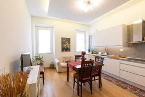 a kitchen and living room with a table and chairs at Trevi Rome Central House in Rome