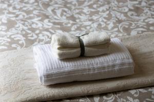 a couple of towels sitting on top of a bed at Trevi Rome Central House in Rome +36 photos