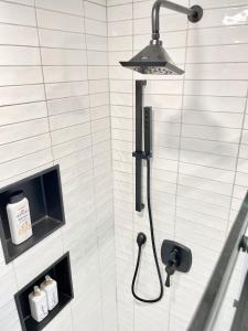 a shower with a shower head in a bathroom at Auberge Glengarry Inn, The Tuscan Suite 