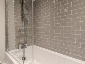 a bathroom with a shower and a bath tub at Penistone View in Keighley +21 photos