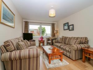 a living room with two couches and a coffee table at 10 Goodhope Gardens in Aberdeen