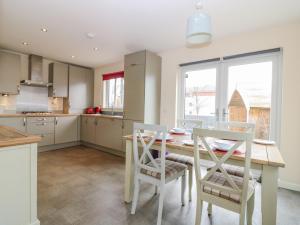 a kitchen with a table and chairs and a window at 10 Goodhope Gardens in Aberdeen