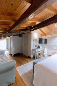 a bedroom with a bed and a desk in a room at Kastello Hotel in Nafplio