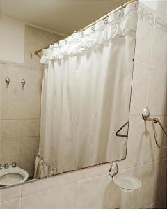 a bathroom with a shower curtain and a sink at Departamento para 3 in Esquel