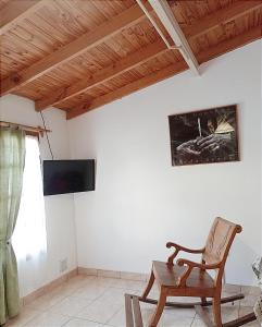 a living room with a chair and a television at Departamento para 3 in Esquel