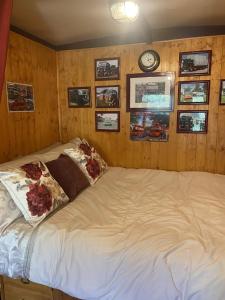 a bed in a room with a clock on the wall at Rare 1954 Renovated Vintage Lorry - Costal Location in Plymouth