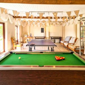 a pool table in a living room with a pool at Ta Mill Cottages & Lodges - Pump Cottage in Launceston